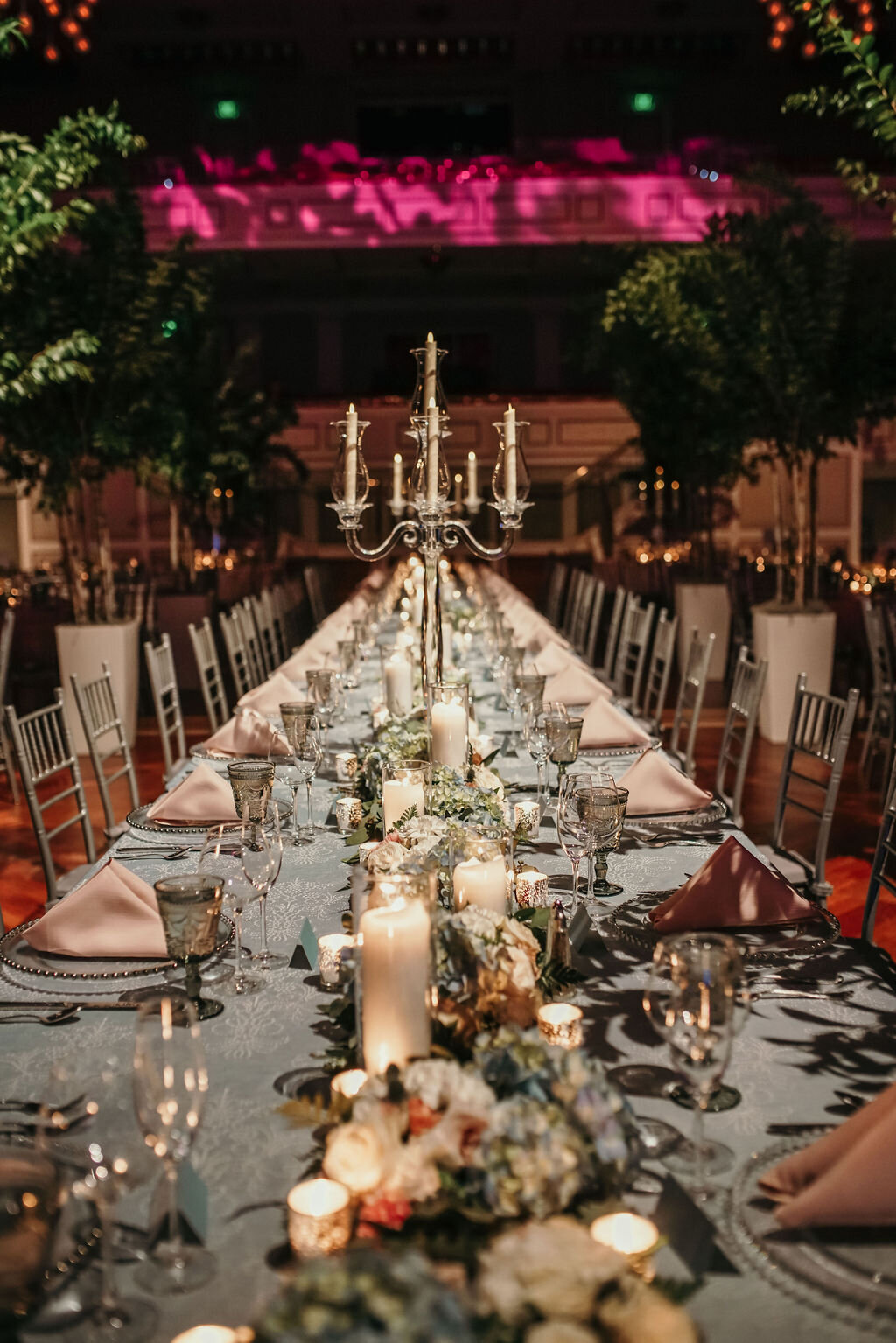 Long candlelit reception tablescape with florals
